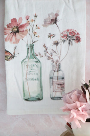 Flour sack towel with old fashioned bottles and flowers