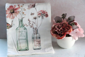 Flour sack towel with old fashioned bottles and flowers